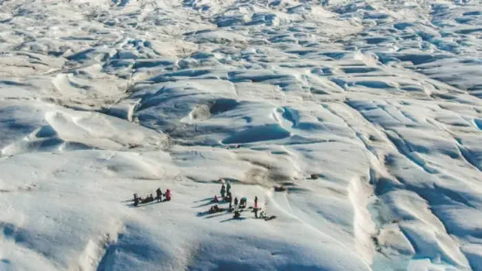 Adventure tourists walking on the glacier
