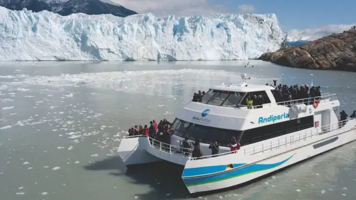 Embarcación navegando frente al glaciar
