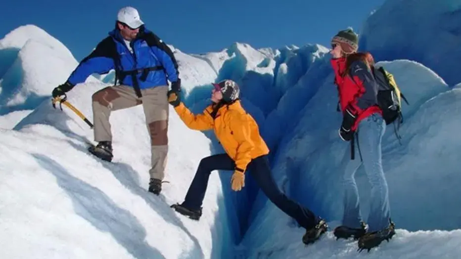 Adventure tourists walking on the glacier